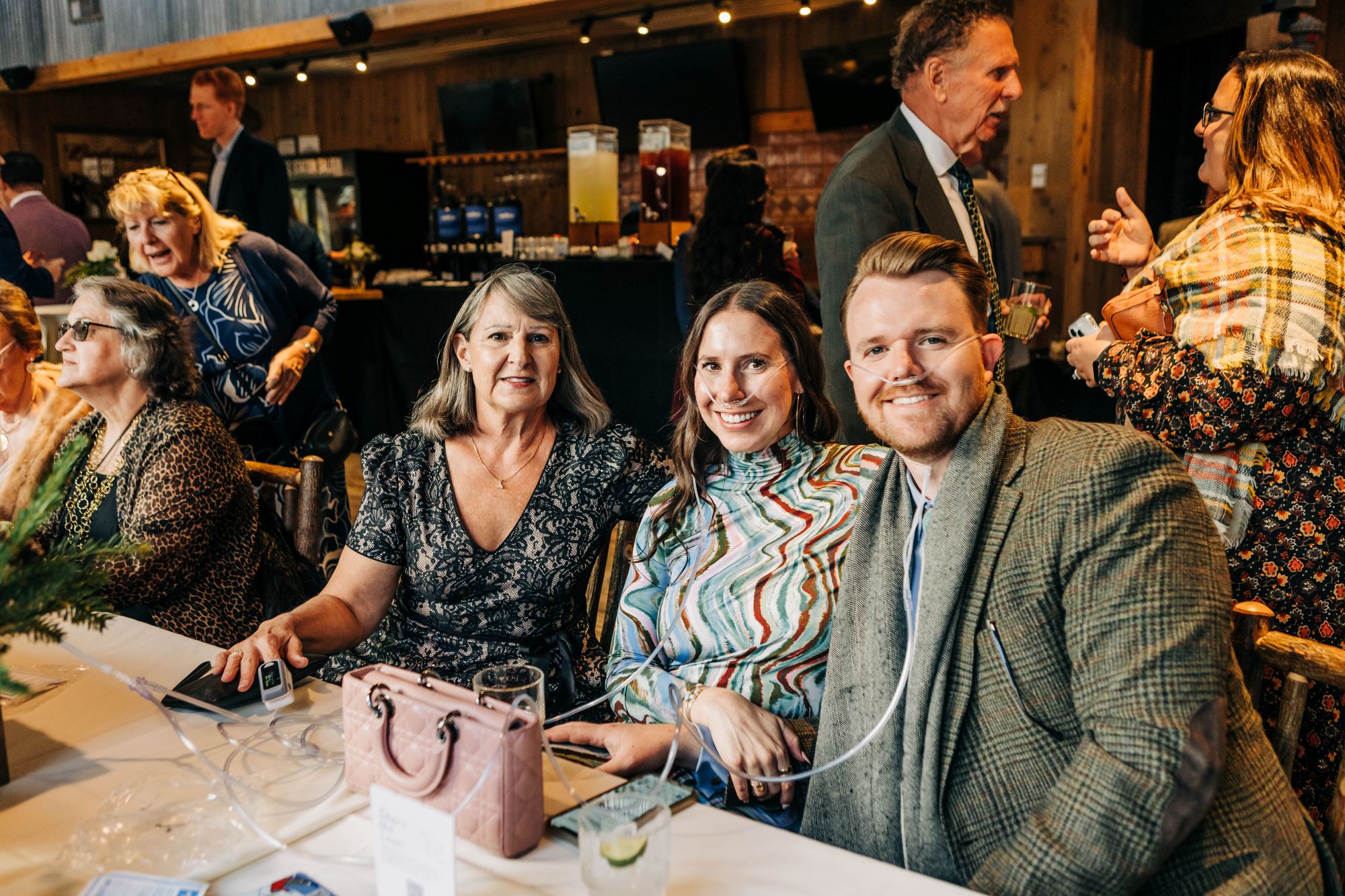 Wedding guests smiling and enjoying the Colorado Mountain Oxygen bar experience